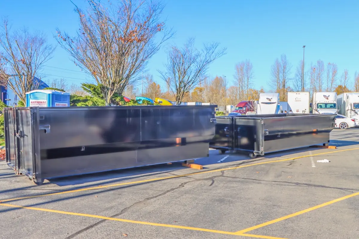 Professional dumpster rental service with roll-off container on residential driveway in Alhambra